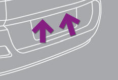 Insert a thin screwdriver into one of the outer holes of the lens.